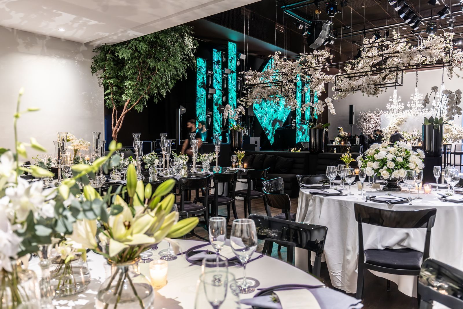 Elegant corporate gala setup with dressed tables and a lit stage