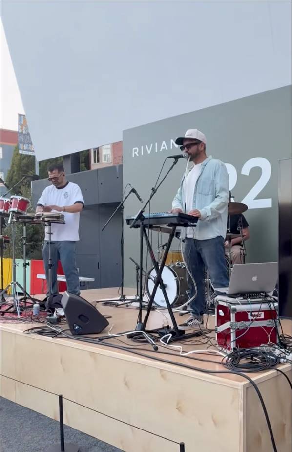 Live band performing outdoors at Rivian event