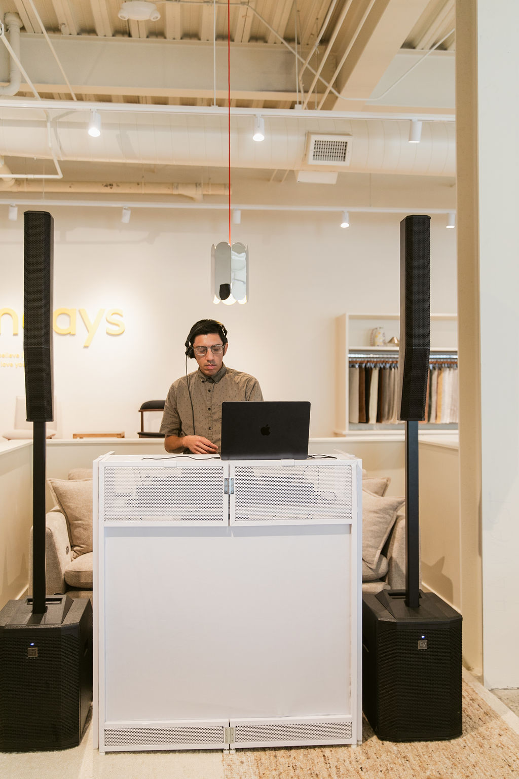 DJ setup with speakers in a refined retail space