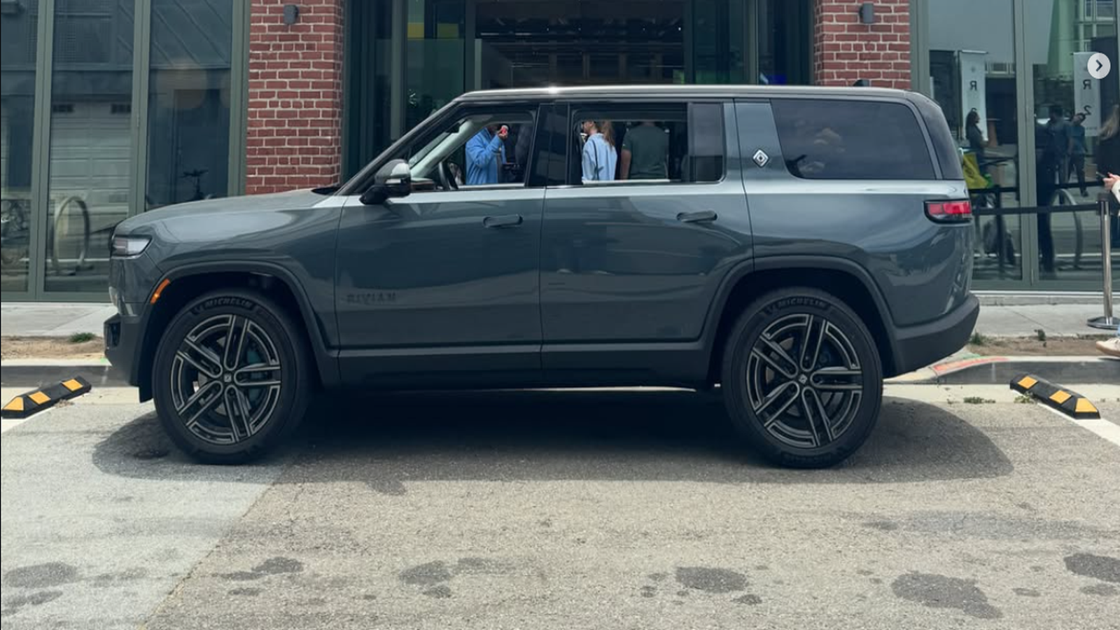 Rivian R2 electric SUV side profile at a San Francisco showroom