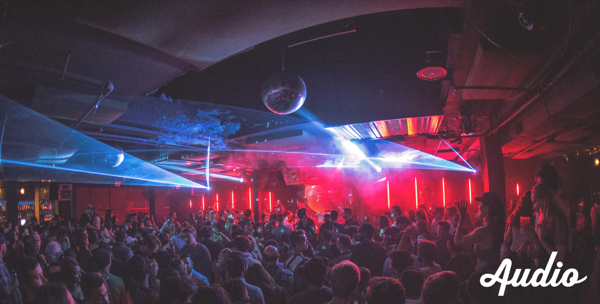 Packed nightclub with lasers and lighting
