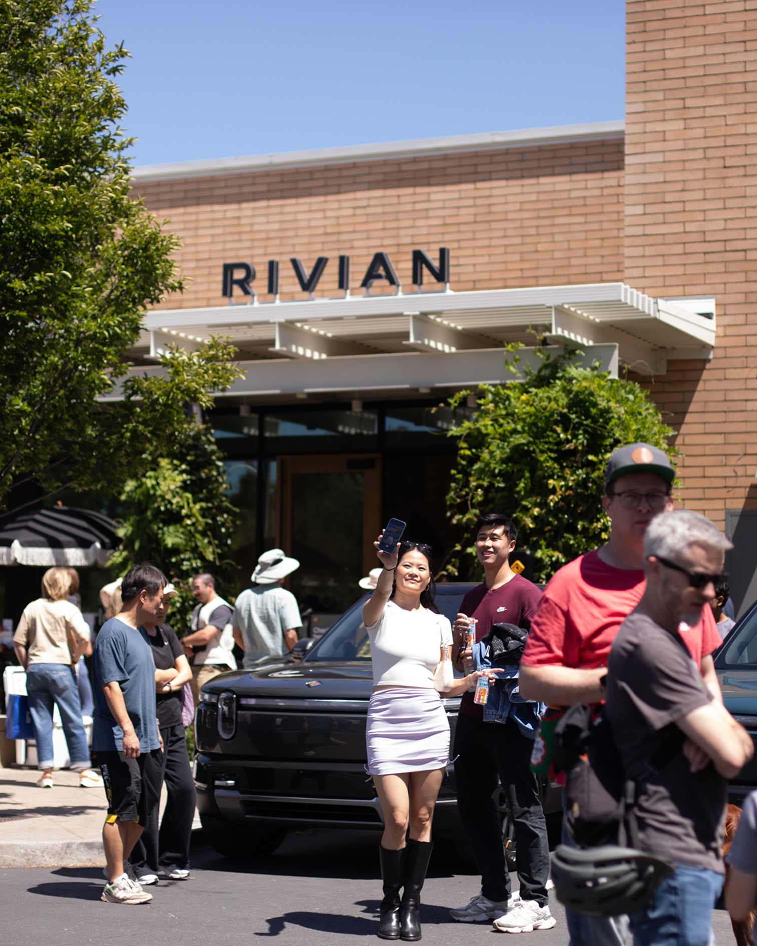 Guests at Rivian R2 block party outside Rivian showroom